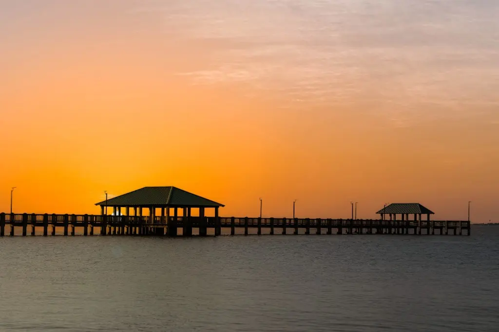 Sunset over a Gulf Coast pier with covered pavilions near Ocean Springs, Mississippi